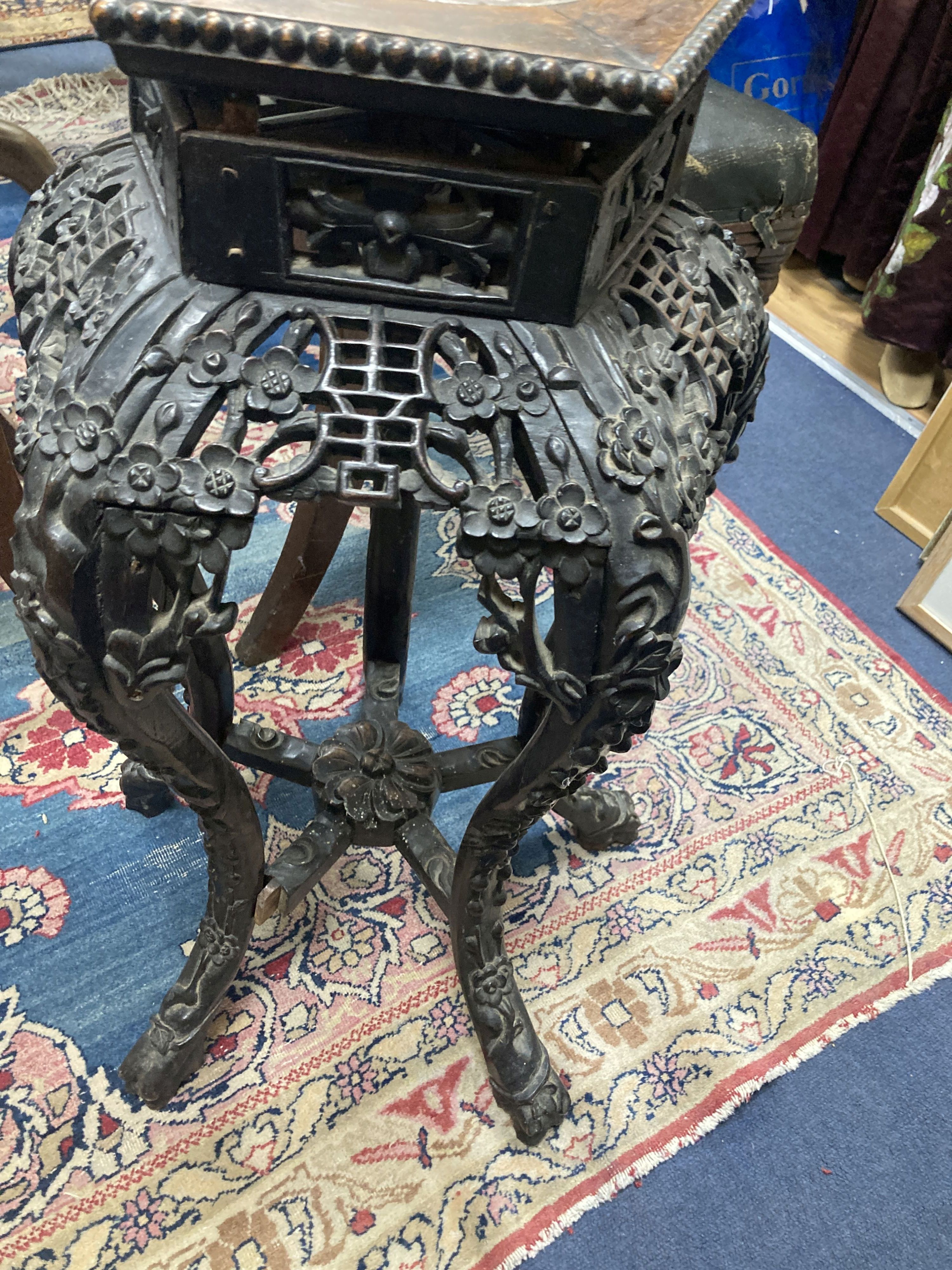 A late 19th/early 20th century Chinese carved jardiniere stand, 65cm. high